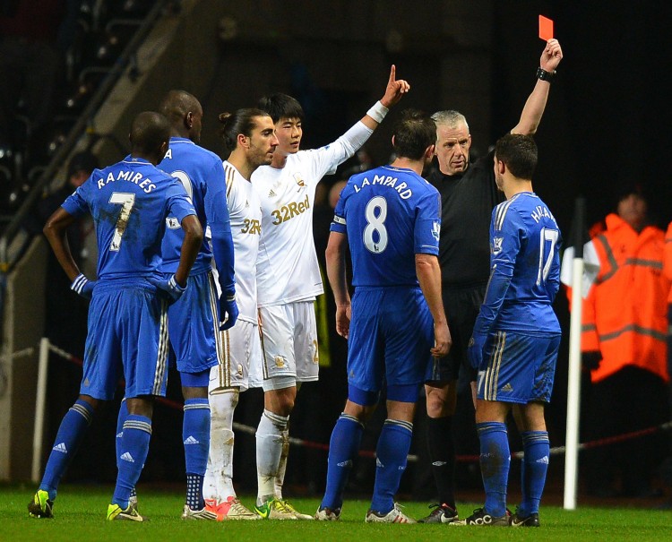 Eden Hazard of Chelsea (R) is shown a red car for having kicked a ball boy in the Carling Cup semifnal against Swansea City on Wednesday, Jan. 23, 2013. (Andrew Yates/AFP/Getty Images)