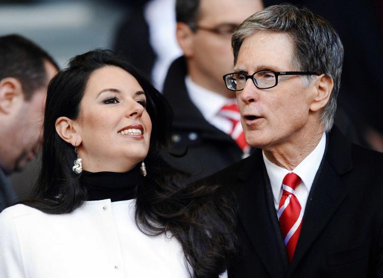 Co-owner of Liverpool, John W. Henry (R), and his partner Linda Pizzuti attend at Anfield last Sunday's blockbuster match against Chelsea. (Paul Ellis/AFP/Getty Images)