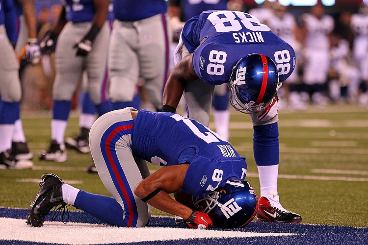 DÉJÀ VU: Domenik Hixon of the New York Giants kneels on the turf in pain after a touchdown catch on September 19 against the Saint Louis Rams at MetLife Stadium. It was revealed on Tuesday that Hixon tore his ACL on the play and will undergo season-ending knee surgery for the second year in a row. The Giants may also be without wide receiver Mario Manningham, who left Sunday's game with concussion symptoms. The Giants, who appeared set at wide receiver before the season, may be wishing they had signed Steve Smith after all. (Getty Images/Al Bello)