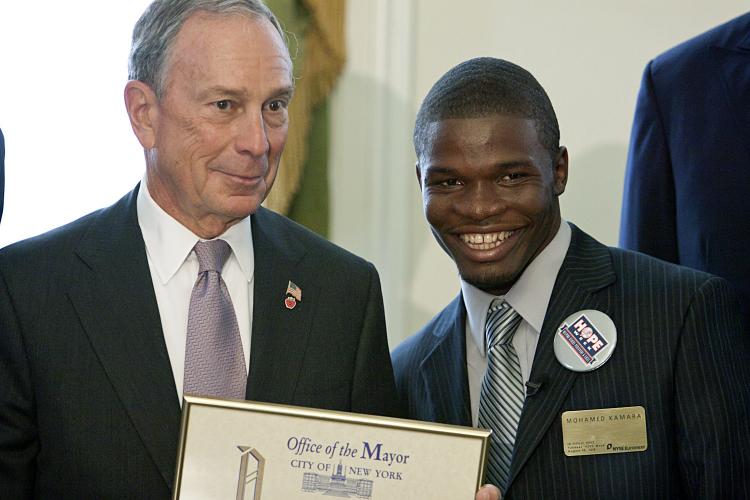 HONOREE: Mayor Michael Bloomberg presents Mohamed Kamara the Hope Week award at city Hall on Wednesday. (Henry Lam/The Epoch TImes)