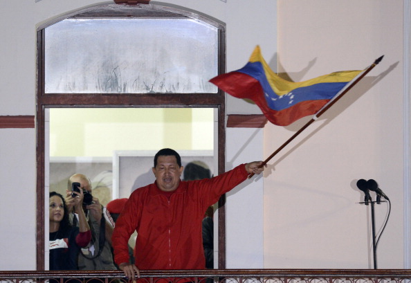 Venezuelan President Hugo Chavez waves a Venezuelan flag while speaking to supporters after receiving news of his reelection in Caracas on October 7, 2012. According to the National Electoral Council, Chavez was reelected with 54.42% of the votes, beating opposition candidate Henrique Capriles, who obtained 44.97%. (Juan Barreto/AFP/GettyImages)