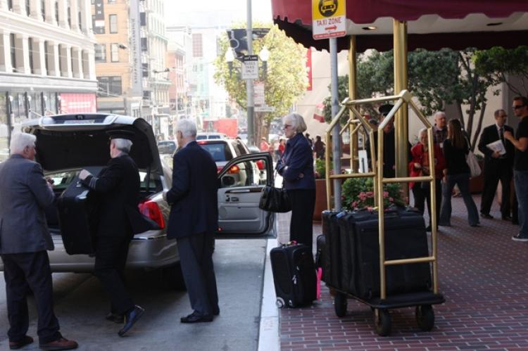 A San Francisco Hyatt Regency worker loads a cab with hotel guests' suitcases. Workers at Hyatt Regency in San Francisco went on strike early Tuesday morning to protest increased workloads. (Ivailo Anguelov/Epoch Times)