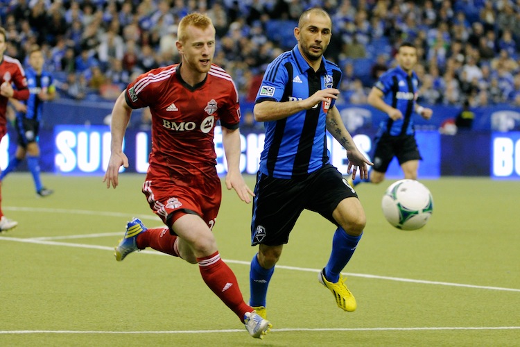 Toronto FC's Richard Eckersley (L) and Montreal Impact's Marco Di Vaio compete for the ball in MLS action at Montreal's Olympic Stadium on Mar. 16. The Impact won their home opener against their Canadian rivals. (Richard Wolowicz/Getty Images)