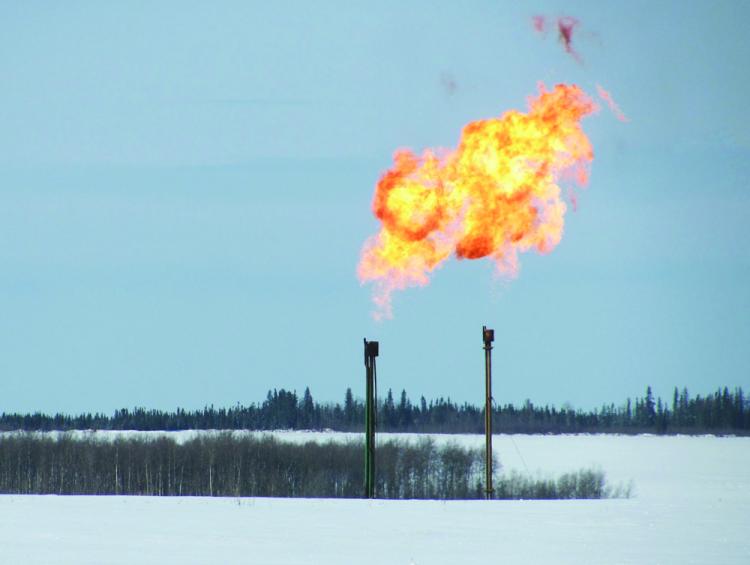 Twin flarestacks are cleaned through 'flaring' at a wellsite near Farmington, B.C., in March 2010. Flarestacks are a common site near homes in B.C.'s Peace region. (Courtesy of Ken John.)