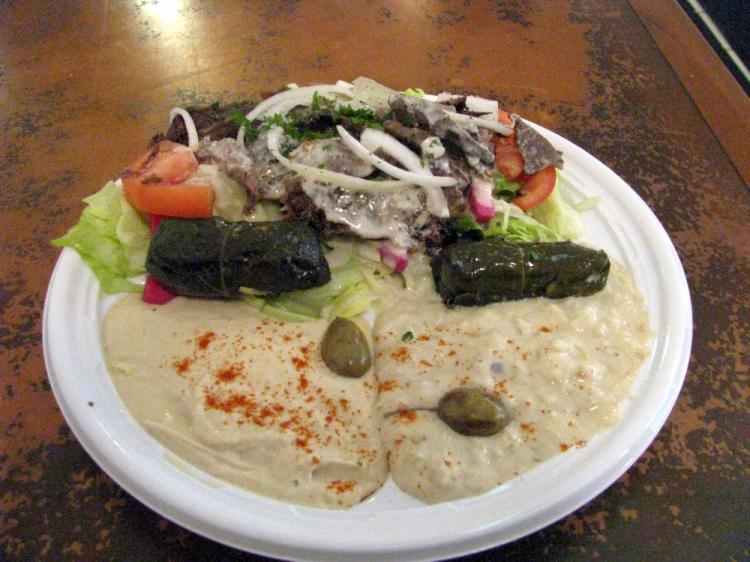 A beef combination platter with salad, grape leave rolls, baba ghanoush, and hummus. (The Epoch Times)