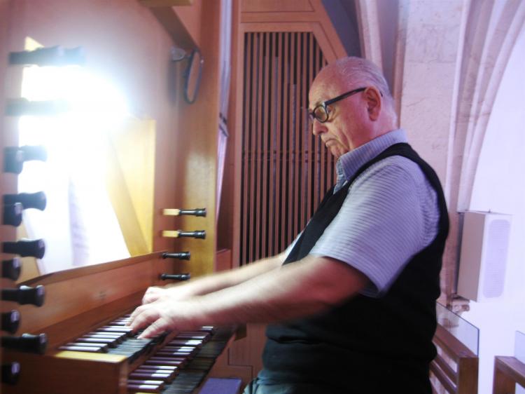 EXPANDING SOUNDS: When Juan Onassis, a famous Israeli painter and musician, plays the church organ, it seems as if he is about to take off into the air.  (Maya Mizrachi/The Epoch Times)