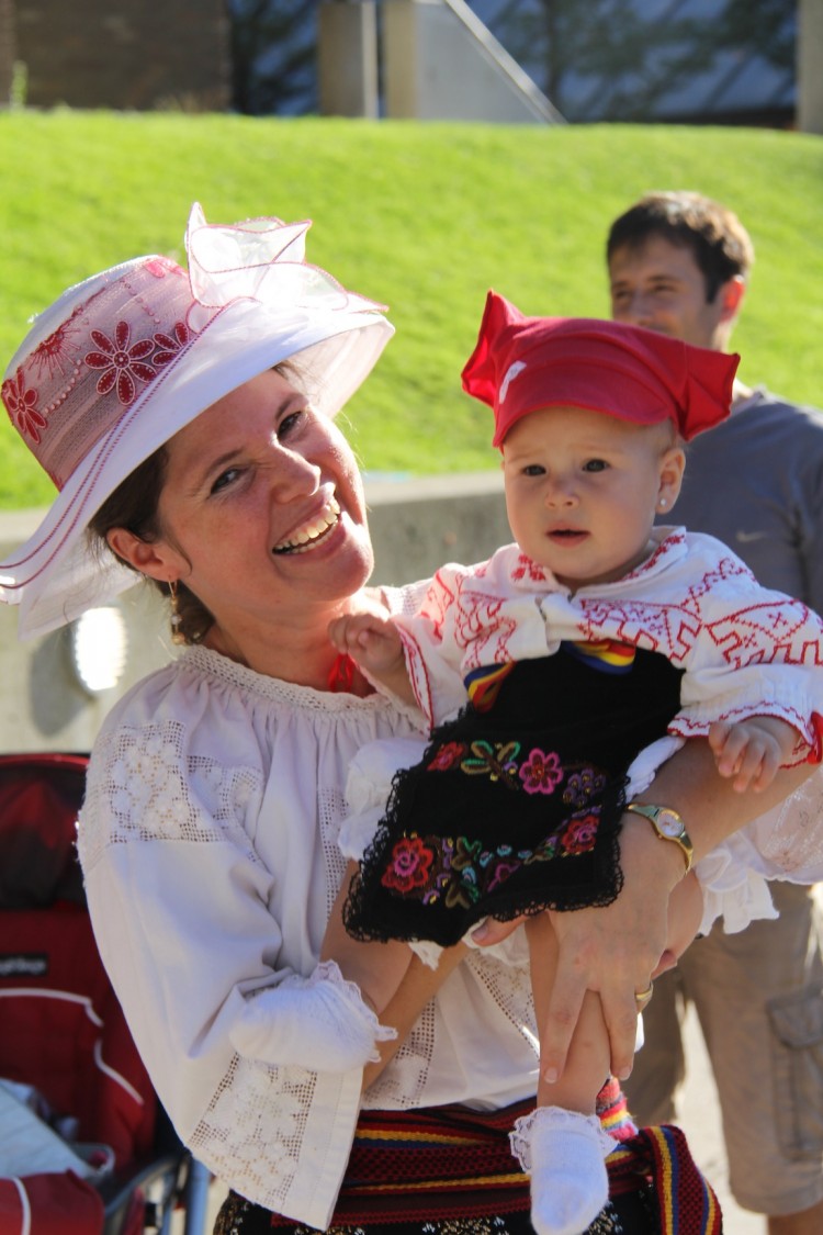 A woman and a child dressed in traditional Romanian costumes pose for a picture at the Romanian Festival Toronto on Saturday, Sept. 1 (Madalina Hubert/The Epoch Times)