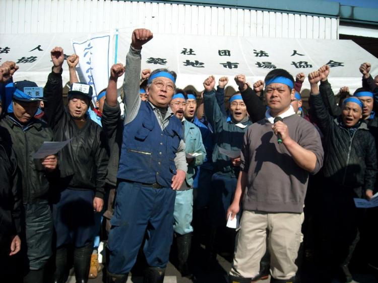 Japanese fishmongers raise their fists in the air as they hold a rally to protest against a global trade ban on Atlantic bluefin tuna at Tokyo's Tsukiji fish market on March 11.  (STR/AFP/Getty Images)