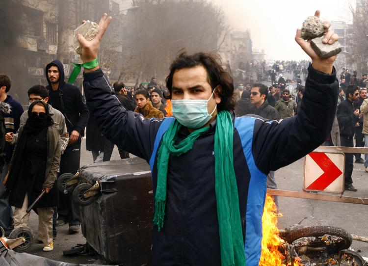 An Iranian opposition supporter gestures during clashes with security forces in Tehran on Dec. 27, 2009. Eleven people have so far been sentenced to death for taking part in opposition protest.   (Amir Sadeghi/AFP PHOTO)