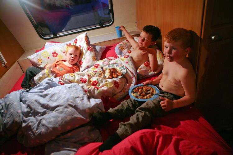 NOT LEAVING: Three children in a trailer at Dale Farm Travellers Site in Essex have dinner before being put to bed, despite a court order to leave the site by midnight wednesday. (Courtesy of Mary Turner)