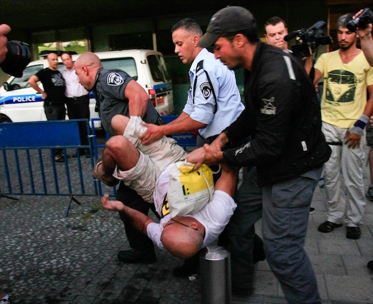 Police arrest housing crisis demonstrators at the back entrance of City Hall on Wednesday. (Yaira Yasmin/The Epoch Times)