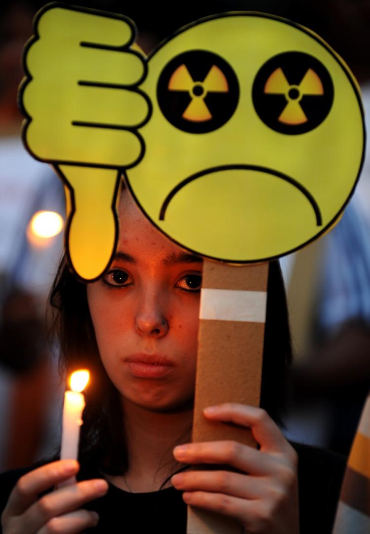 An Indian woman protests nuclear power and show respect for those who died in the Japan earthquake. (Dibyangshu Sarkar/AFP/Getty Images)