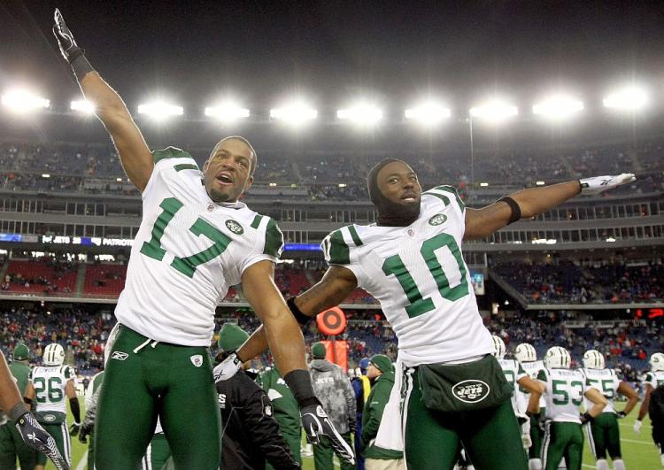 Braylon Edwards and Santonio Holmes celebrate a memorable upset victory over the top-seeded New England Patriots on Sunday. (Al Bello/Getty Images)