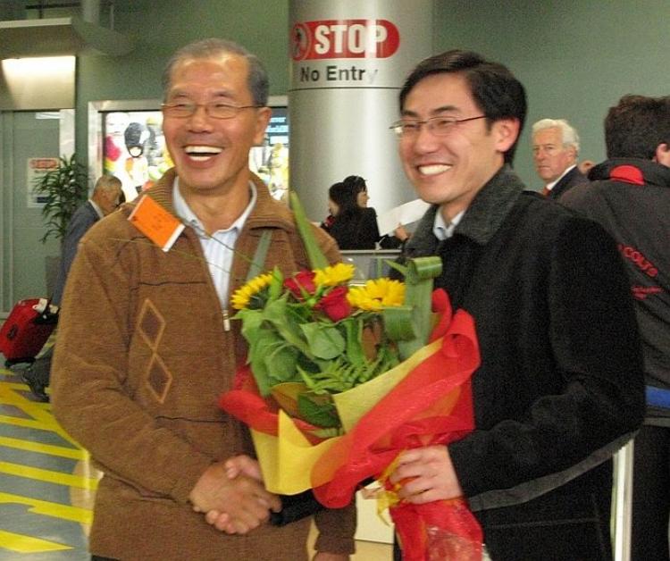 FATHER AND SON: Jia Jia (left) and his son Jia Juo at the New Zealand airport in 2007 when Jia Jia arrived after defecting from the Chinese Communist Party. (The Epoch Times)