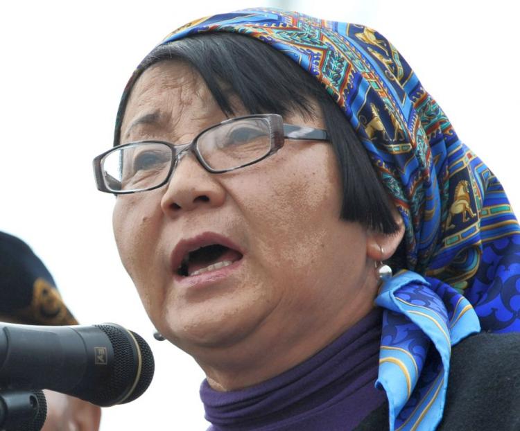 Kyrgyz interim leader Roza Otunbayeva gives a speech during mass burials of the victims at the Ata-Beyit memorial complex on the outskirts of Bishkek on April 10. Some 7,000 people gathered in a sea of flowers at a cemetery on the edge of the capital for Saturday's mass burials, mourning 79 people who died in the uprising during which the government opened fire on protesters. (Vyacheslav Oseledkooo/AFP/Getty Images)