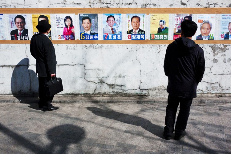 South Korean voters view election posters on April 11.