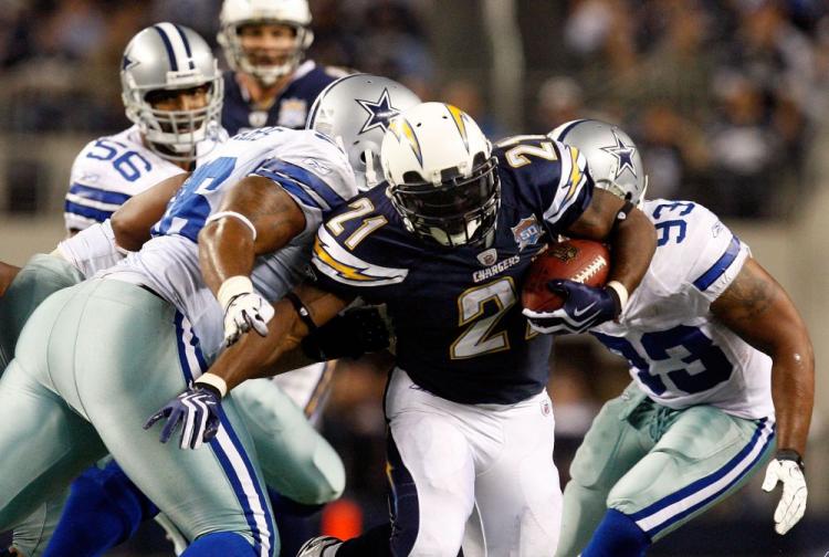 LaDainian Tomlinson blasts through Dallas defense at Cowboys Stadium on Sunday. (Ronald Martinez/Getty Images)