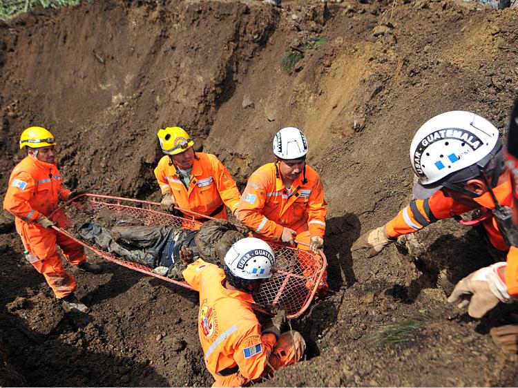 Rescuers retrieve the corpse of a person buried by a landslide in the Nahuala municipality, Solola, west of Guatemala City, on September 5, 2010. (Johan Ordonez/AFP/Getty Images) Rescuers retrieve the corpse of a person buried by a landslide in the Nahuala municipality, Solola, west of Guatemala City, on September 5, 2010. (Johan Ordonez/AFP/Getty Images)