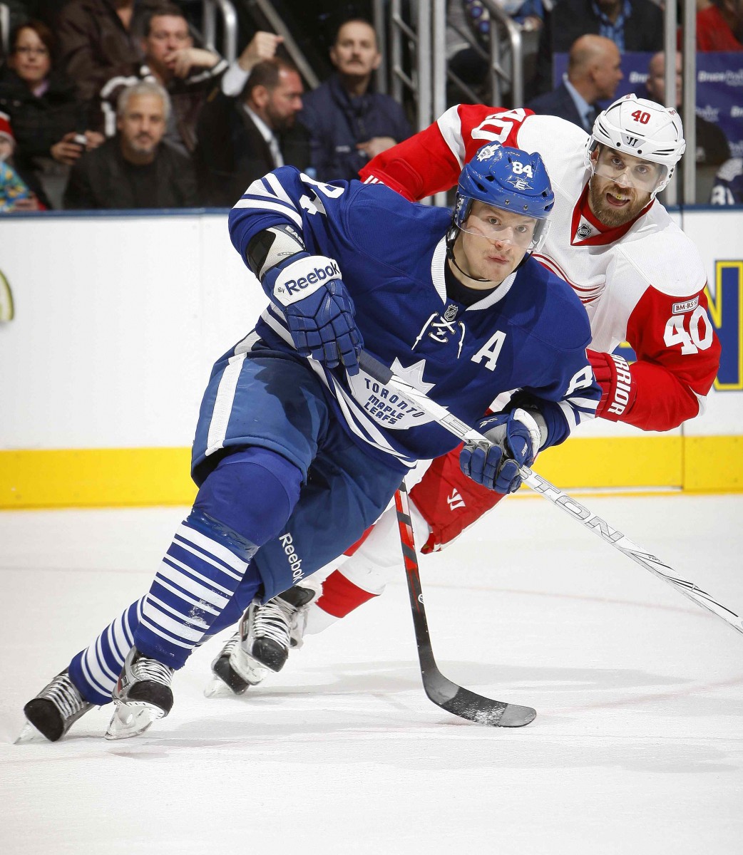 Mikhail Grabovski of the Toronto Maple Leafs is pursued by Henrik Zetterberg of the Detroit Red Wings in a game at the Air Canada Centre on Jan. 7, 2012. The new NHL realignment has Detroit and Toronto in the same division once again. (Abelimages/Getty Images) 
