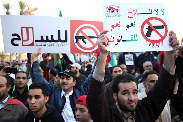 Libyan demonstrators hold a banner