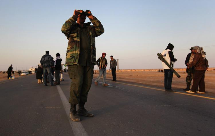 AJDABIYA, LIBYA - MARCH 03: A rebel fighter scans the horizon for government troops on March 3, 2011 in Ajdabiya, Libya. (John Moore/Getty Images)