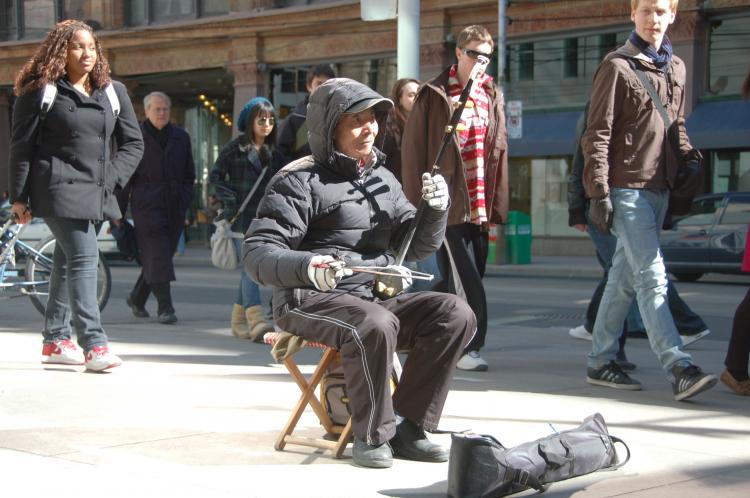 A Chinese man plays an erhu in downtown Toronto. According to Statistics Canada, over half a million Chinese live in Toronto and that number is expected to rise to 1.1 million over the next 20 years. (Matthew Little/The Epoch Times)