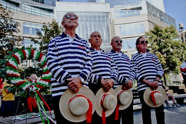 Italian-Americans stand beside the wreath to be placed at the foot of the Christopher Columbus monument in New York on Sunday.  (Tara MacIsaac/The Epoch Times)