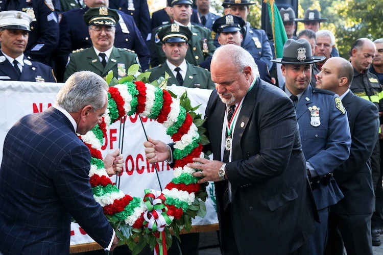 Joseph Guagliardo (R), president of the National Council of Columbian Associations in Civil Service, places a wreath at the foot of the Christopher Columbus monument in New York on Sunday, with Joseph Plumeri (L), Grand Marshal of the 2011 Columbus Day Parade. (Tara MacIsaac/The Epoch Times)