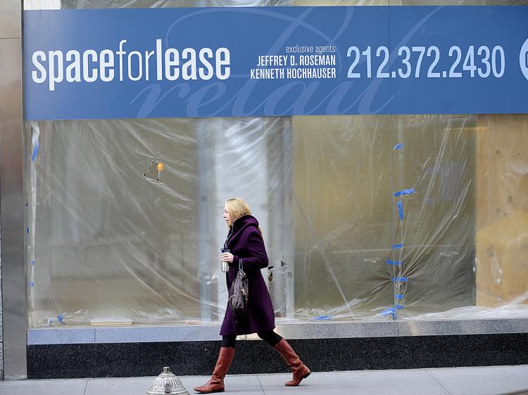 A woman walks past a commercial space for rent on Madison Avenue in New York. (Emmanuel Dunand/AFP/Getty Images)