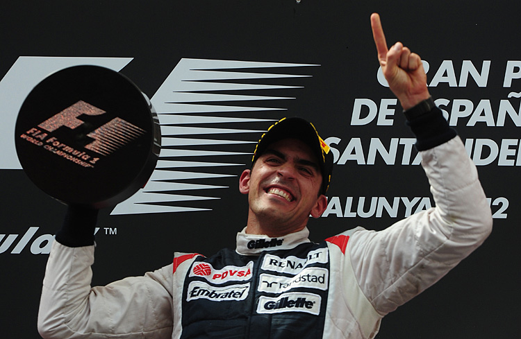 Pastor Maldonado celebrates on the podium at the Circuit de Catalunya after winning the Formula One Spanish Grand Prix. (Dimitar Dilkoff/AFP/GettyImages)