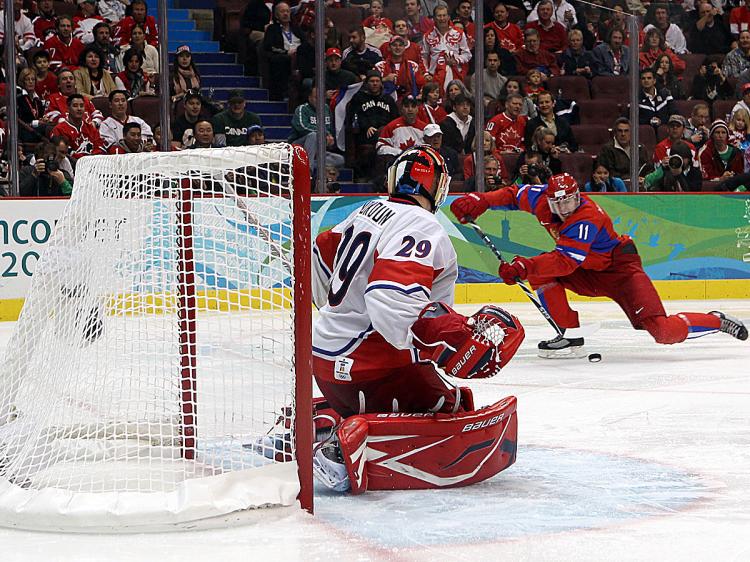 Evgeni Malkin scores the winner after a big hit by Alexander Ovechkin. (Bruce Bennett/Getty Images)