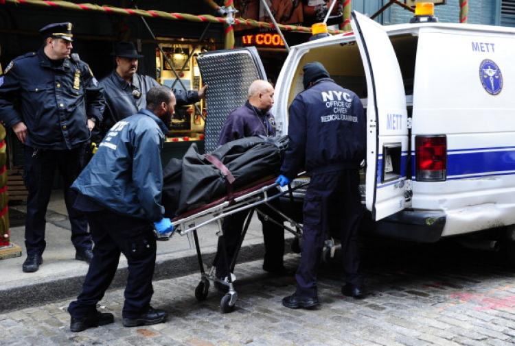 The body of Mark Madoff, the son of disgraced financier Bernard Madoff, is removed by medical examiners after he apparently hanged himself in his New York apartment on Dec. 11, 2010, the second anniversary of his father's arrest for perpetrating Wall Street's biggest ever fraud. (Emmanuel Dunand/AFP/Getty Images)
