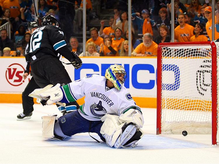 Goaltender Roberto Luongo #1 of the Vancouver Canucks looks back at the puck in the net after Patrick Marleau #12 of the San Jose Sharks' breakaway goal in the first period in Game Three of the NHL Western Conference Finals. (Victor Decolongon/Getty Images)