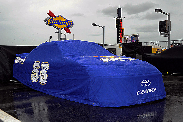 The #55 Aaron's Toyota of Mark Martin sits covered on the grid Sunday. The rain has remained in central Florida, pushing back the start time of the Daytona 500 until 7 p.m. Monday. (John Harrelson/Getty Images for NASCAR)