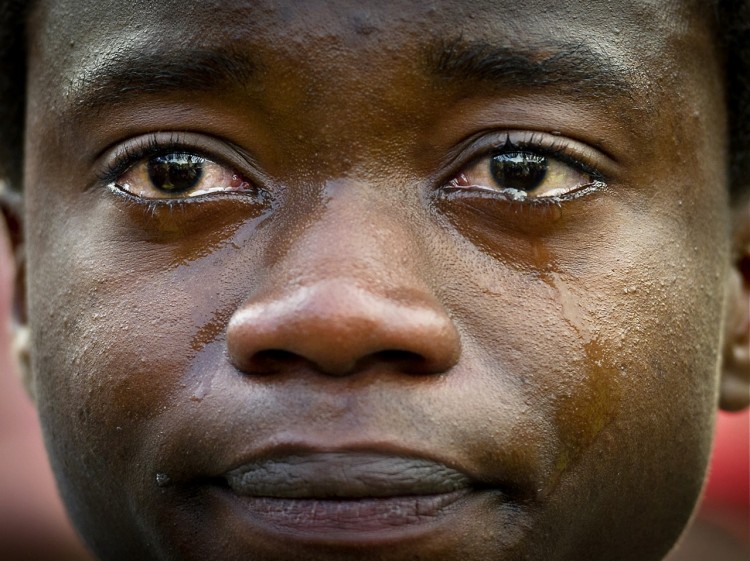 Young Angolan asylum seeker, Mauro, cries during a rally in The Hague, on Nov. 1, amidst supporters who planned to submit a petition with more than 55,000 signatures in support of his application to stay in the Netherlands. (Koen van Weel/AFP/Getty Images)