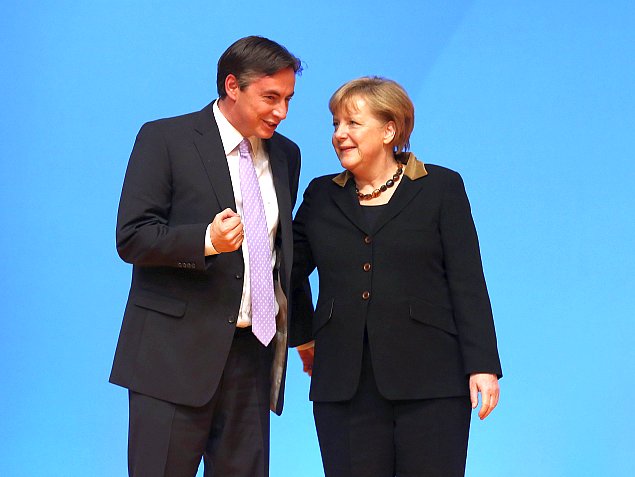 German Chancellor Angela Merkel, who is also chairwoman of the German Christian Democratic Union (CDU), greets delegates with Gov. of Lower Saxony David McAllister after both spoke at the CDU federal party convention in Hanover, Germany, on Dec. 4, 2012. Lower Saxony is holding state election on Jan. 20 and some analysts see the election as a bellwether for general election scheduled to take place later this year. (Sean Gallup/Getty Images)