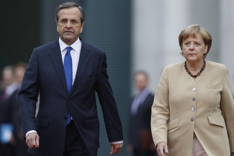 German Chancellor Angela Merkel and Greek Prime Minister Antonis Samaras review a guard of honor upon Samaras arrival at the Chancellery on Aug. 24, 2012 in Berlin, Germany. (Andreas Rentz/Getty Images)