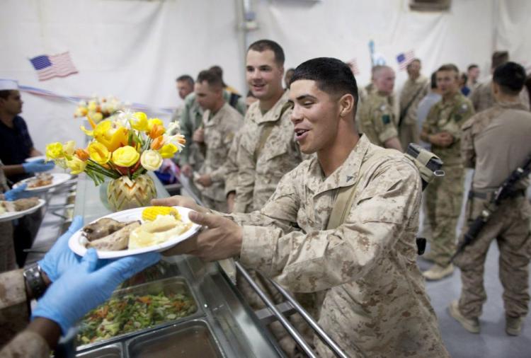 U.S. Marines are served turkey dinners in the main dining facility during the annual Thanksgiving meal at Camp Leatherneck last week. A recommendation to extend federal pay freezes to military personnel excludes Iraq and Afghanistan troops.  (Paula Bronstein/Getty Images)