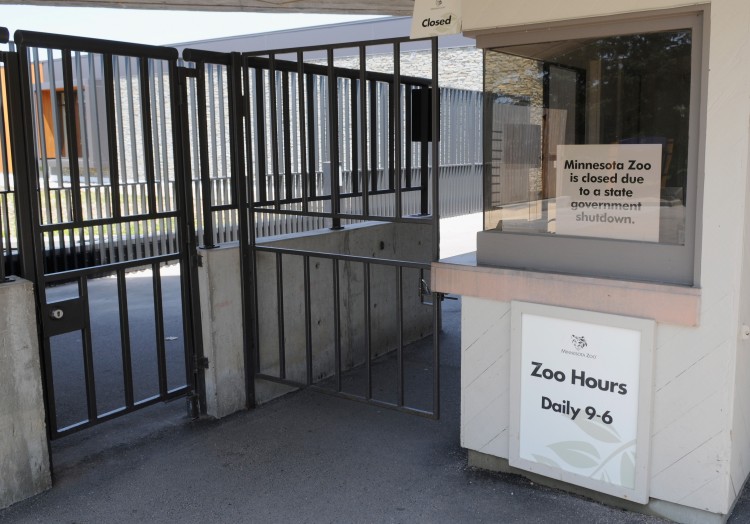GOVERNMENT CLOSURES: A sign displayed on the door of the Minnesota Zoo in Apple Valley, Minn., reads that the facility is closed as the state began the broadest shutdown of state services in its history on July 1. (Hannah Foslien/Getty Images )