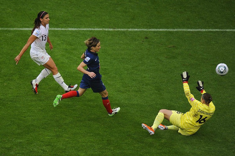 FINISHER: Alex Morgan (L) scores past France's goalkeeper Berangere Sapowicz (R) during their FIFA Women's World Cup semi-final match. (Odd Andersen/AFP/Getty Images)