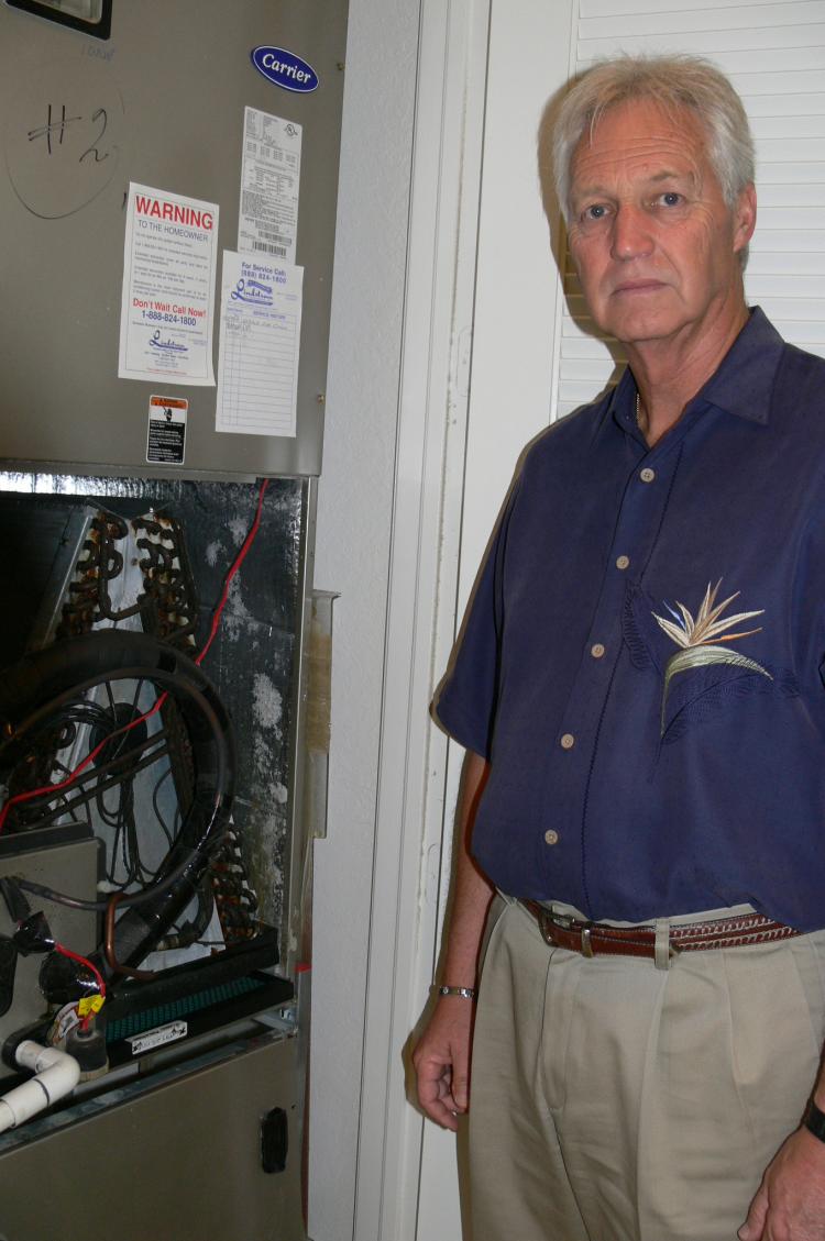 Gary Schultheis stands next to the blackened coils of an air conditioning unit in his Parkland, Florida, home. Schultheis and his wife, Mary Ann, traced their health problems and the chemical smell permeating their home to tainted Chinese drywall.  (Linda Li/The Epoch Times)