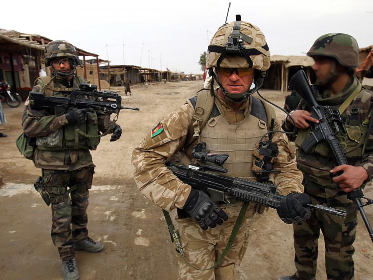 NATO TROOPS: A British soldier (C) of the 1st batallion of the Royal Welsh patrols jointly with French soldiers of the 21st RIMA in the streets of Showal in Nad-e-Ali district, Southern Afghanistan, in Helmand Province. (Thomas Coex/AFP/Getty Images)