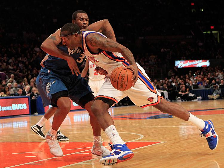 POWER THROUGH: Amar'e Stoudemire drives past Trevor Booker in Monday night's match-up between the New Yorks Knicks and Washington Wizards. (Chris Trotman/Getty Images)