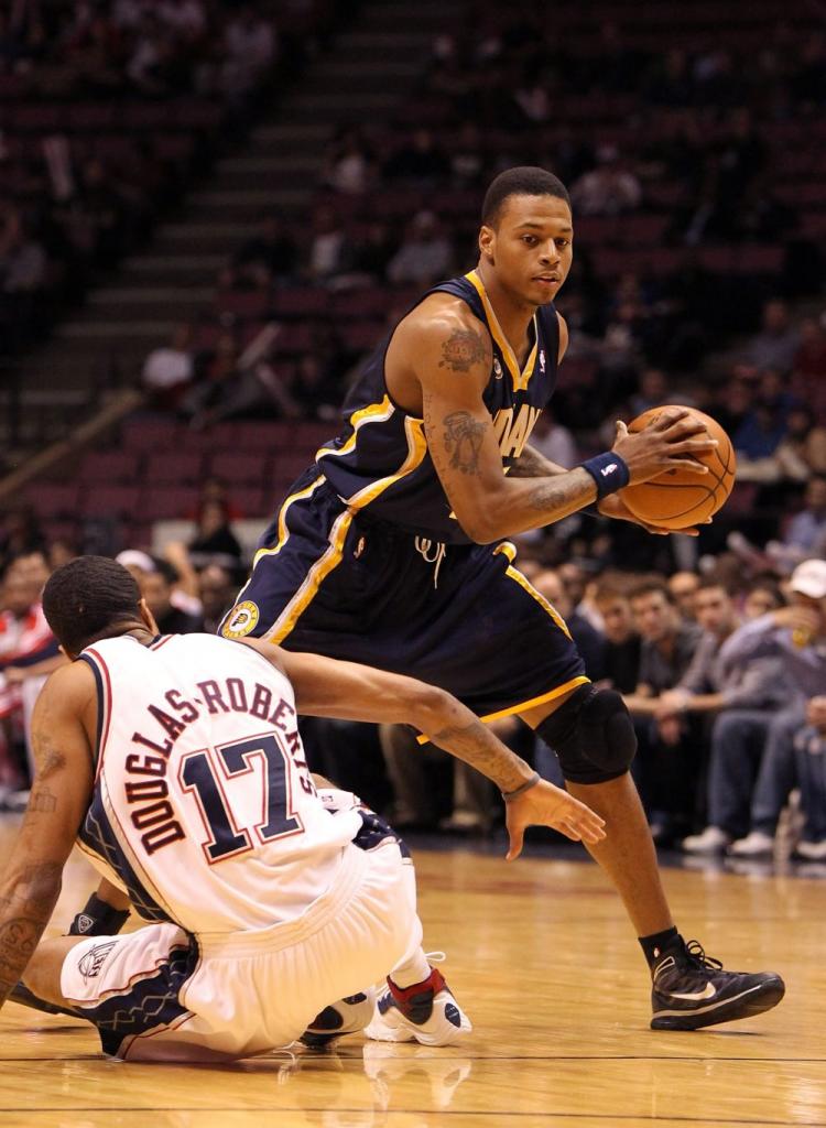 Brandon Rush of the Indiana Pacers makes a move past a fallen Chris Douglas-Roberts of the New Jersey Nets in Tuesday night's game. (Al Bello/Getty Images )