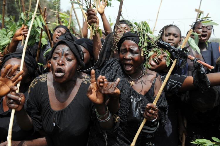 Nigerian women demonstrate in Jos, Nigeria, on March 11, to mourn the over 100 people, many women and children, who died in ethnic clashes and to protest the lack of government protection during the massacre. (Pius Utomi Ekpei/AFP/Getty Images)