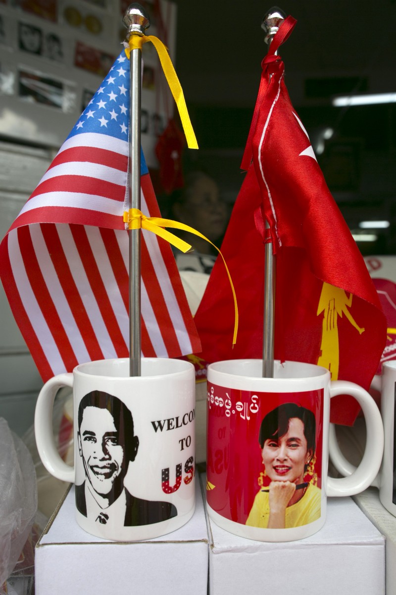 Mugs and flags showing US President Barack Obama and Burmese opposition leader Aung San Suu Kyi are displayed in a shop in Yangon Burma as the city prepares for the US Presidents forthcoming visit on November 16. (Photo by Paula Bronstein/Getty Images)  