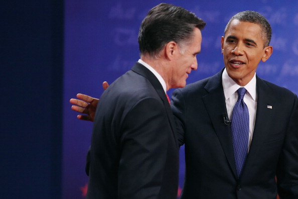 Democratic presidential candidate, U.S. President Barack Obama (R) pats Republican presidential candidate, former Massachusetts Gov. Mitt Romney on the back after the Presidential Debate at the University of Denver on October 3, 2012 in Denver, Colorado. The first of four debates for the 2012 Election, three Presidential and one Vice Presidential, is moderated by PBS's Jim Lehrer and focuses on domestic issues: the economy, health care, and the role of government. (Photo by Chip Somodevilla/Getty Images)