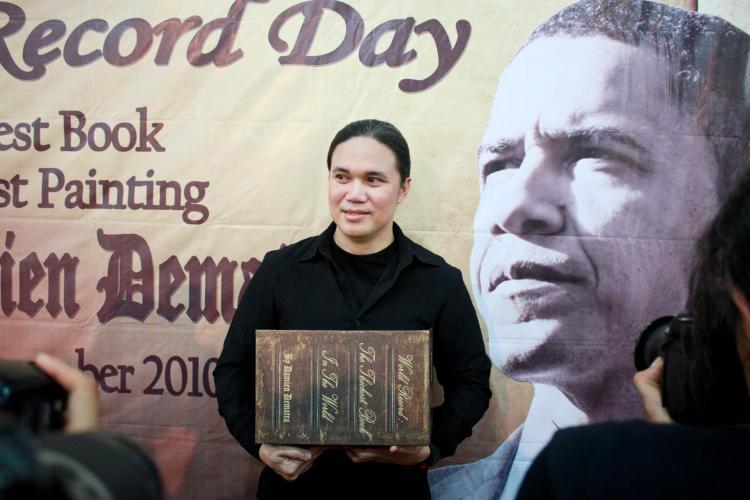BIG BOOK: Author Damien Dematra hold up his latest book 'Obama and Pluralism' at his book launching in Jakarta on Nov. 9. The launch took place while U.S. President Barack Obama was visiting Indonesia, a country where he spent several years in his youth. (M Bachtiyar/The Epoch Times)