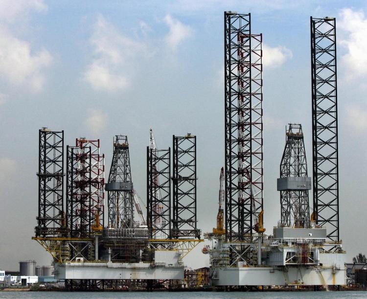 Two jack-up rigs stand at shipyard in Singapore. OPEC estimates that demand for oil would grow by 900,000 barrels per day in 2010. (Roslan Rahman/AFP/Getty Images)
