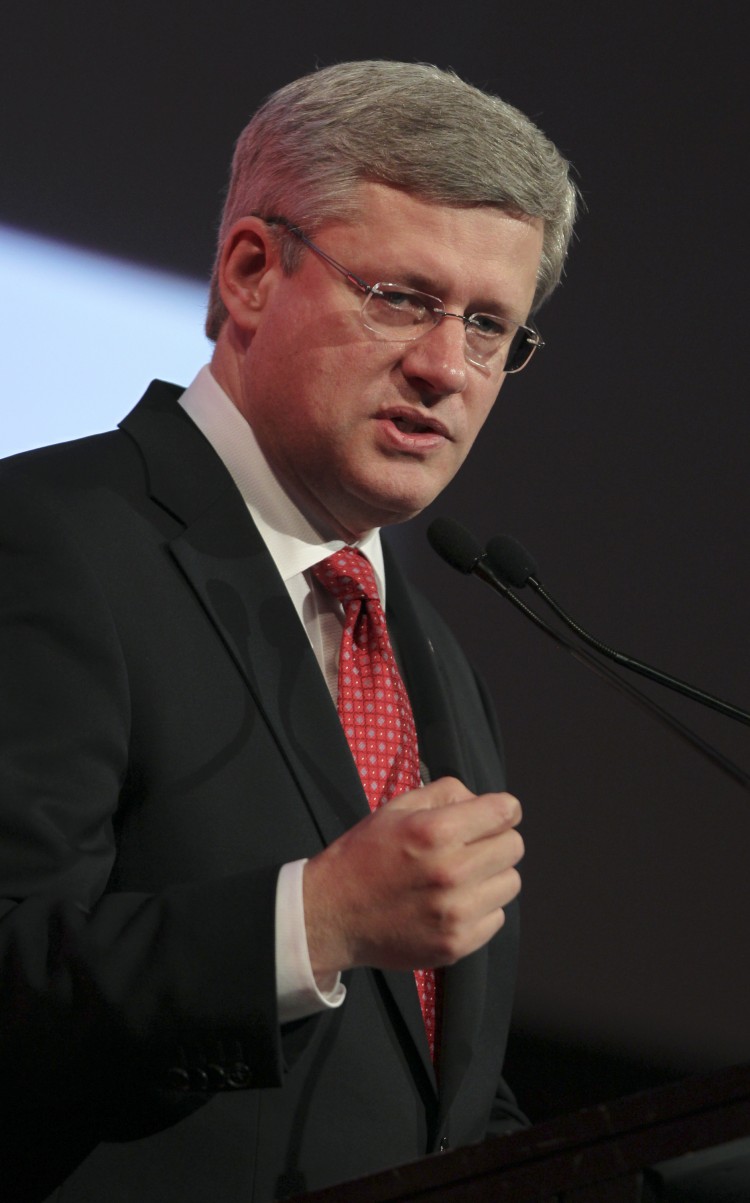 Prime Minister Stephen Harper delivers the keynote address to close the Commonwealth Business Forum in Perth on Oct. 27 ahead of the Commonwealth Heads of Governments Meeting (CHOGM) this week. The CHOGM talks, to be opened by Britain's Queen Elizabeth II on Oct. 28, will debate whether the body should adopt a charter of common values and create the office of commissioner for democracy, rule of law, and human rights. (Tony Ashby/AFP/Getty Images)